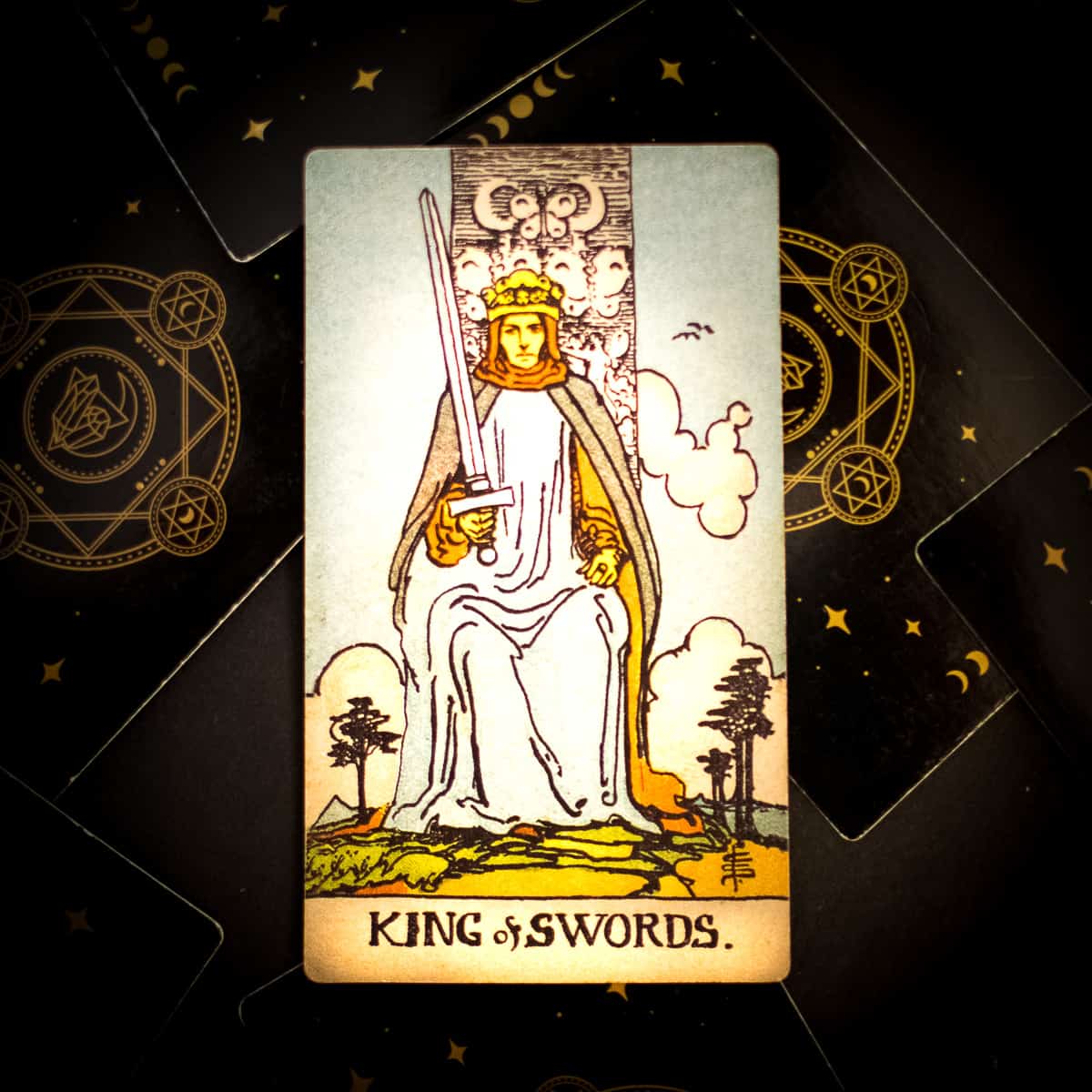 The King of Swords tarot card showing a king sitting on a throne holding a sword.