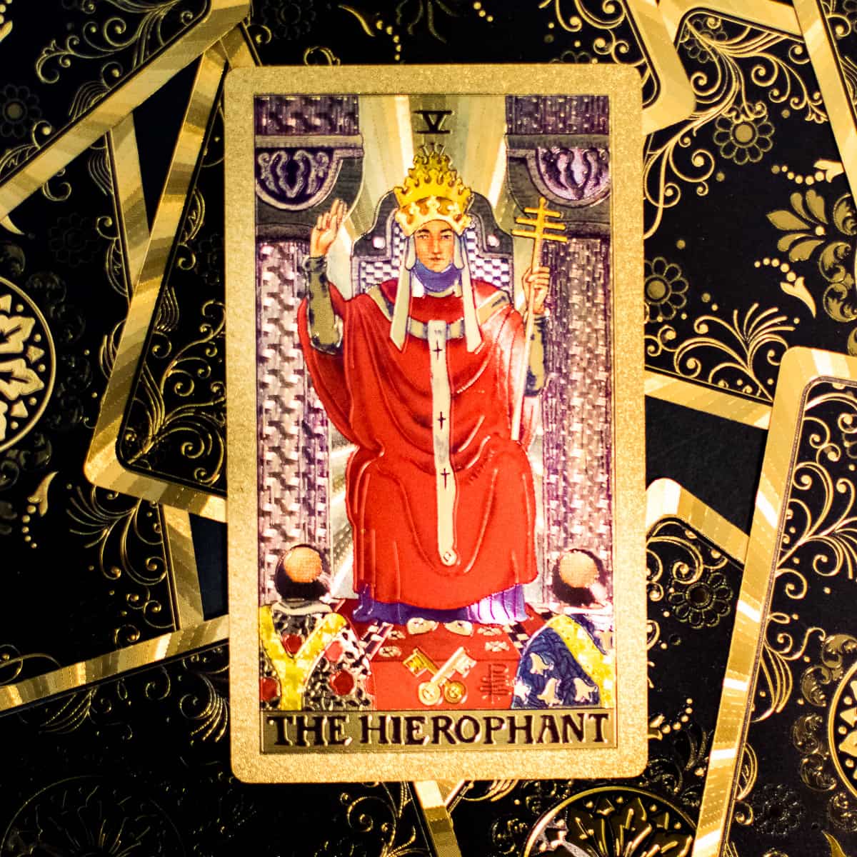 The Hierophant tarot card on top of a pile of cards. 