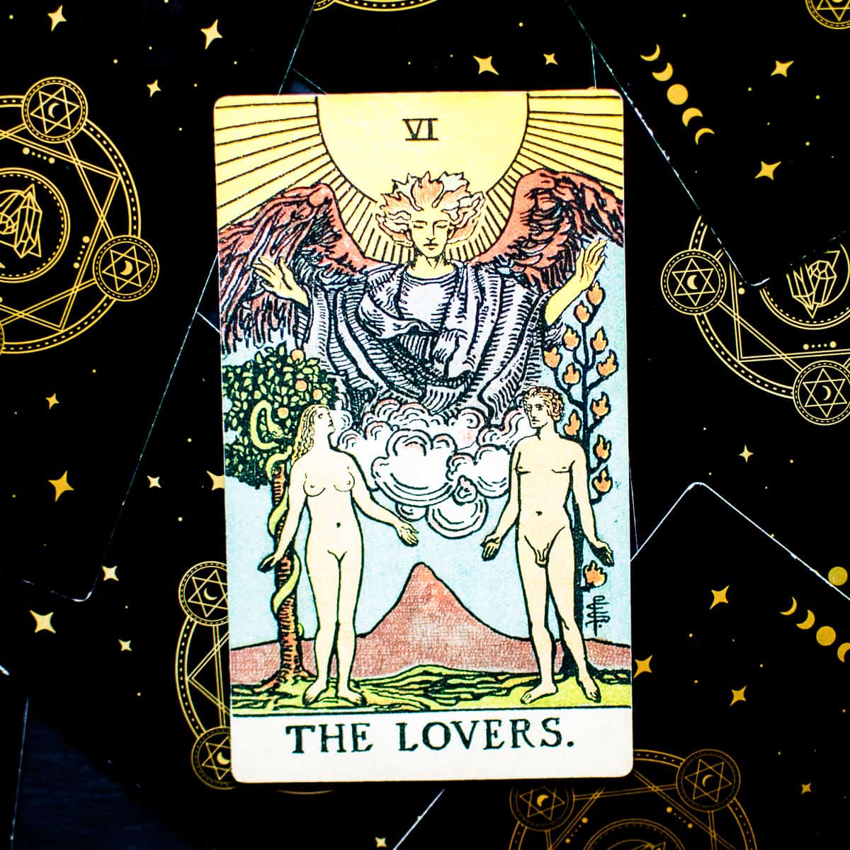 A man and woman looking at each other on The Lovers card from the deck of Tarot. 