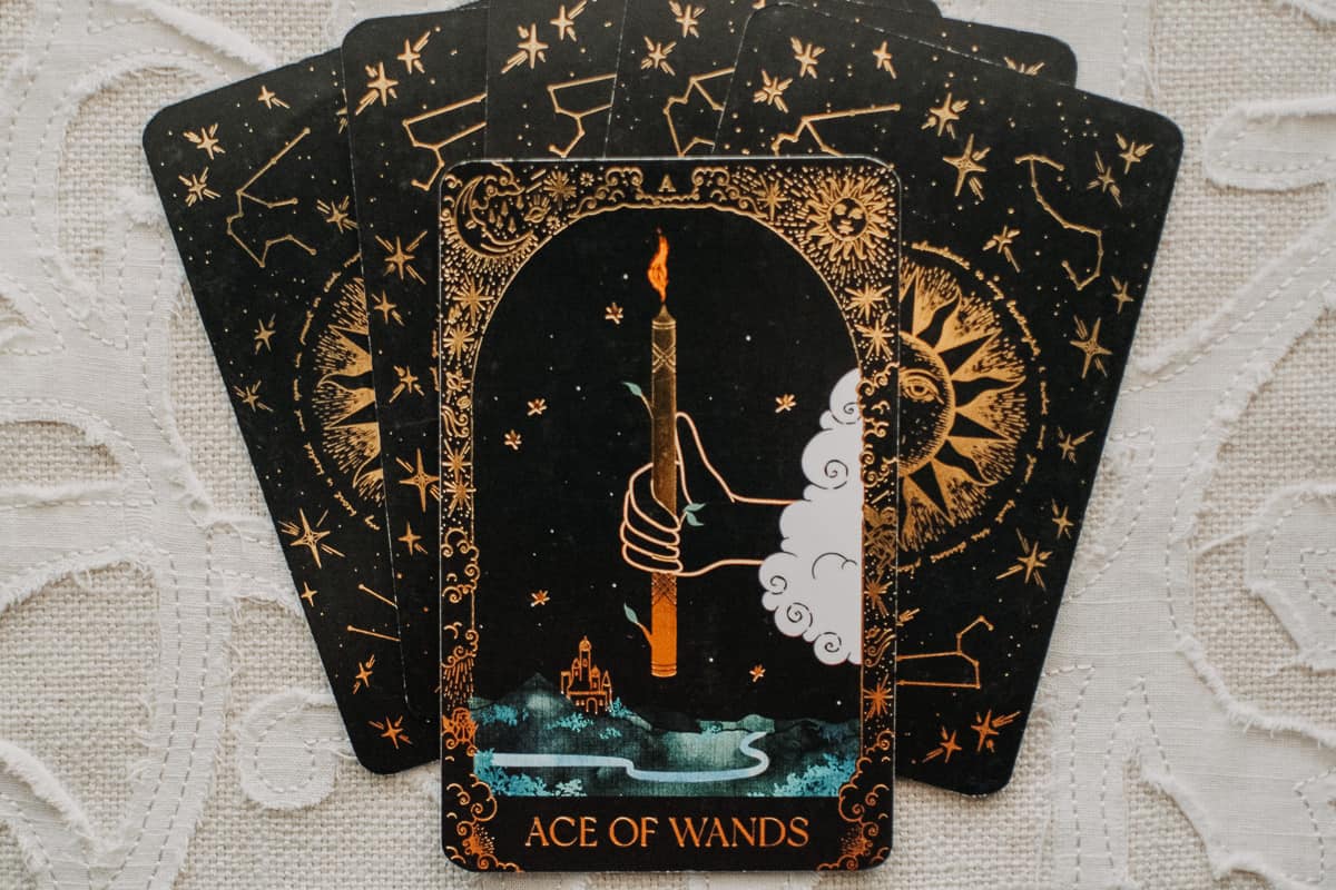 The Ace of Wands on a stack of tarot cards. 