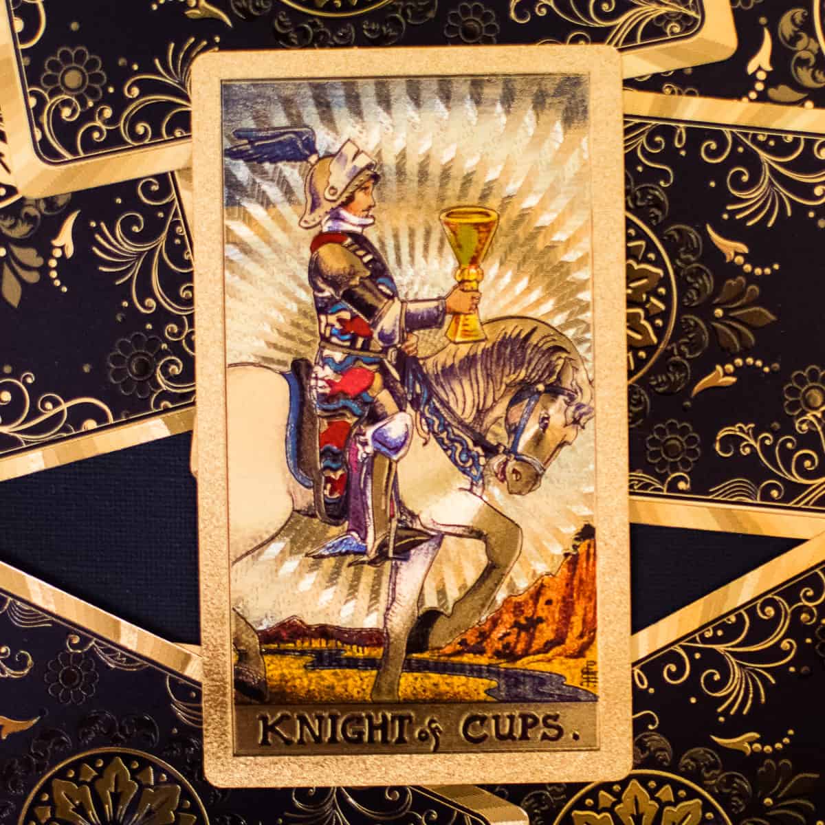 A knight holding a golden cup riding a horse on a tarot card.