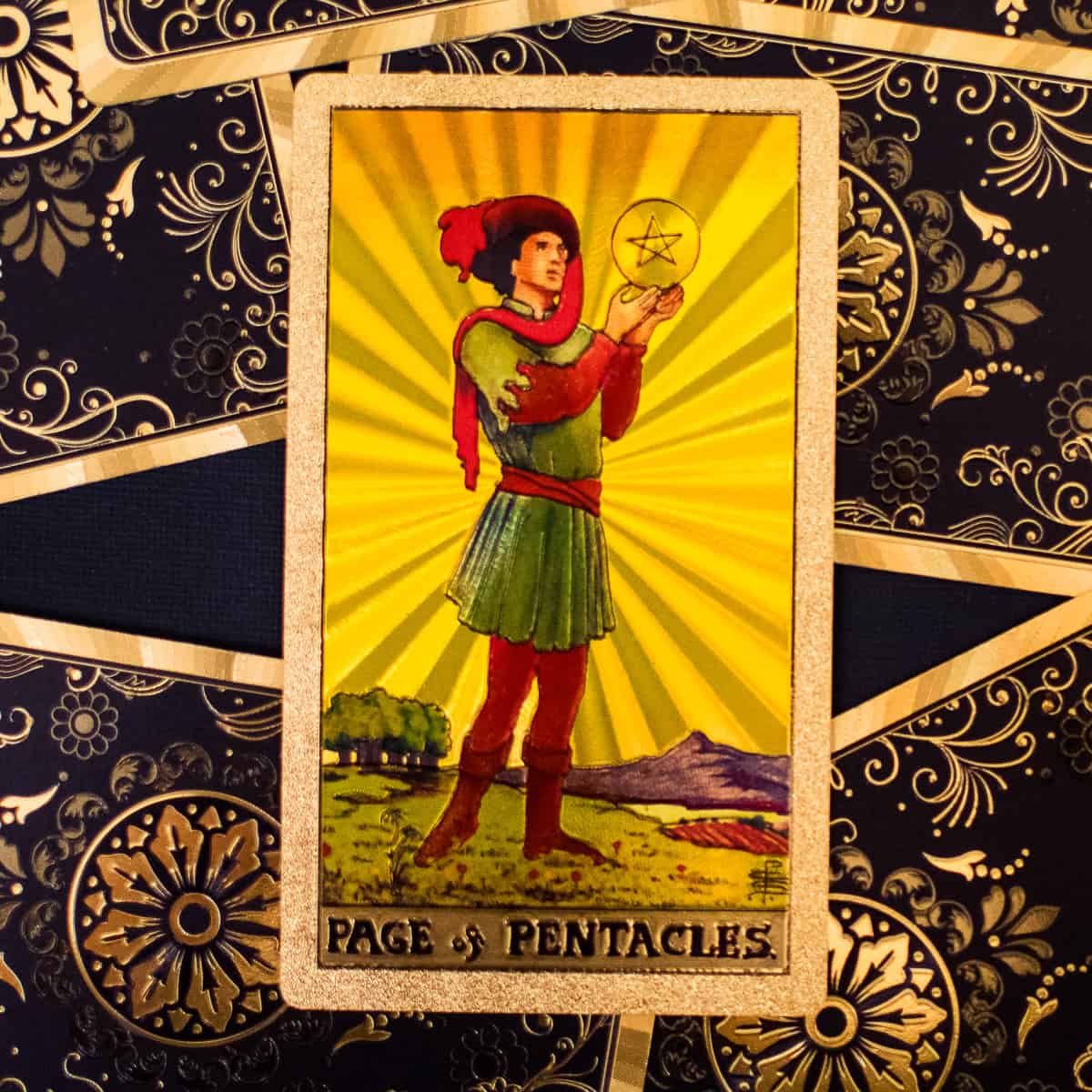 A Page, standing, holding a single pentacle on a tarot card. 