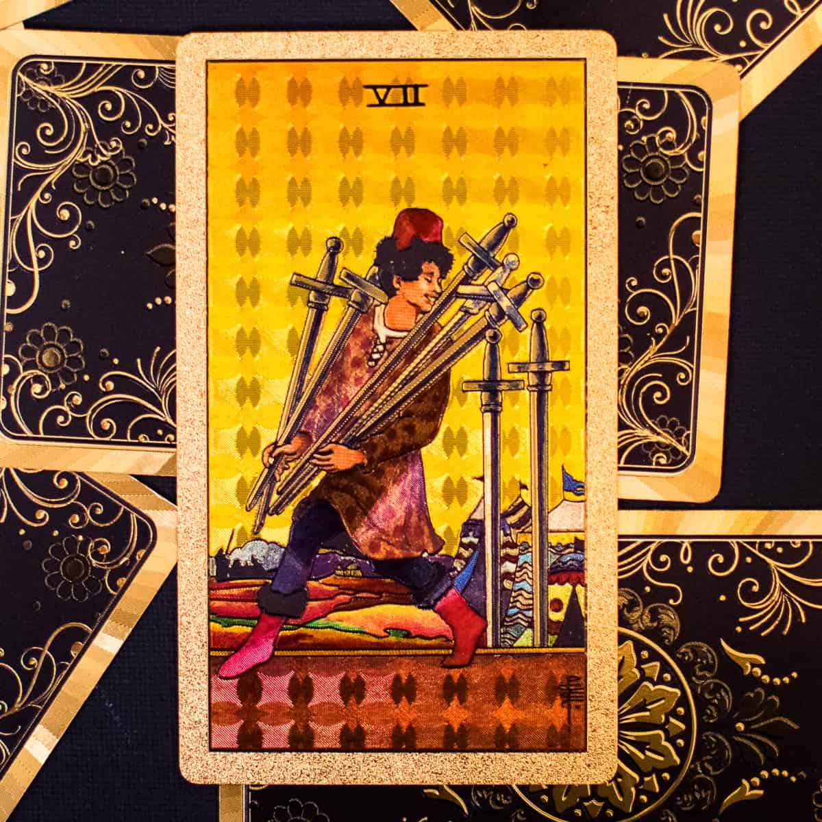 A person carrying 5 swords away while leaving 2 behind depicted on a tarot card.