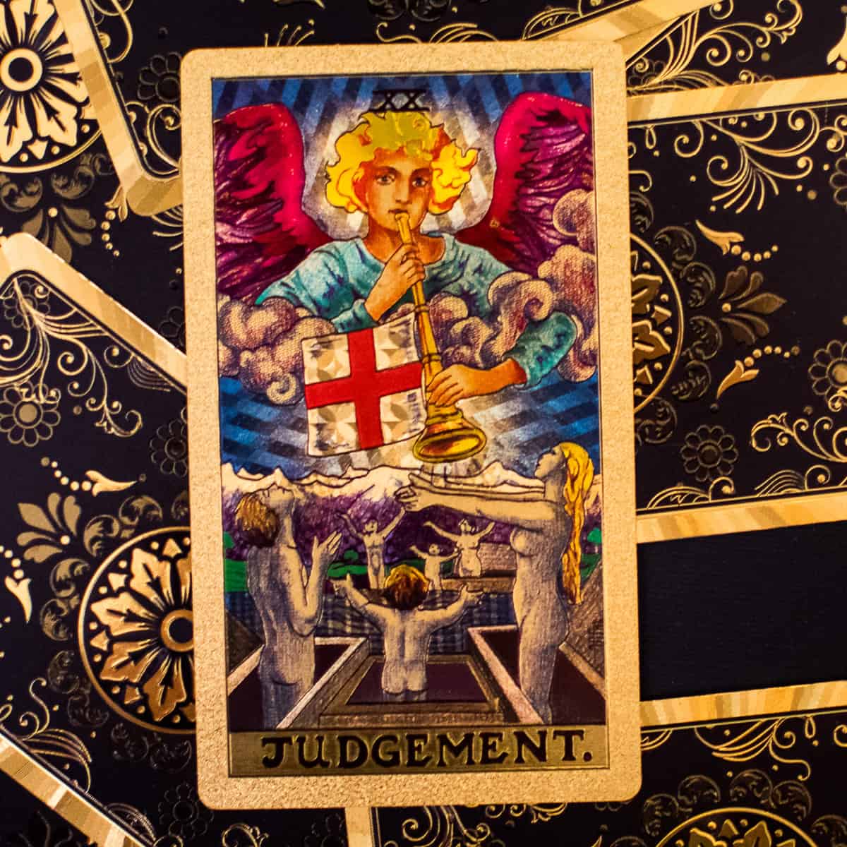 Angel harkening to bodies emerging from graves depicted on a tarot card.