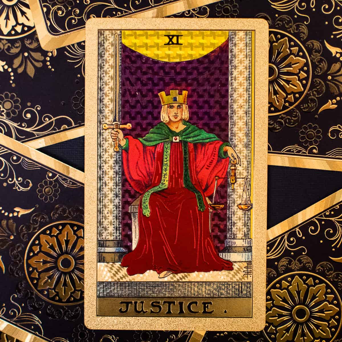 An individual holding scales and a scepter on a tarot card.