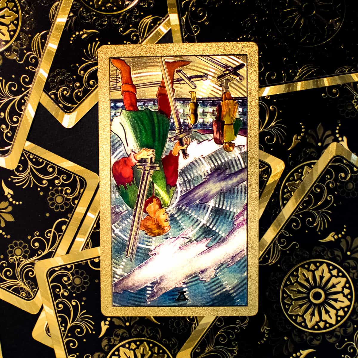Five of Swords tarot card in the reverse position depicting a man stealing 3 swords and leaving 2 behind with his opponents.