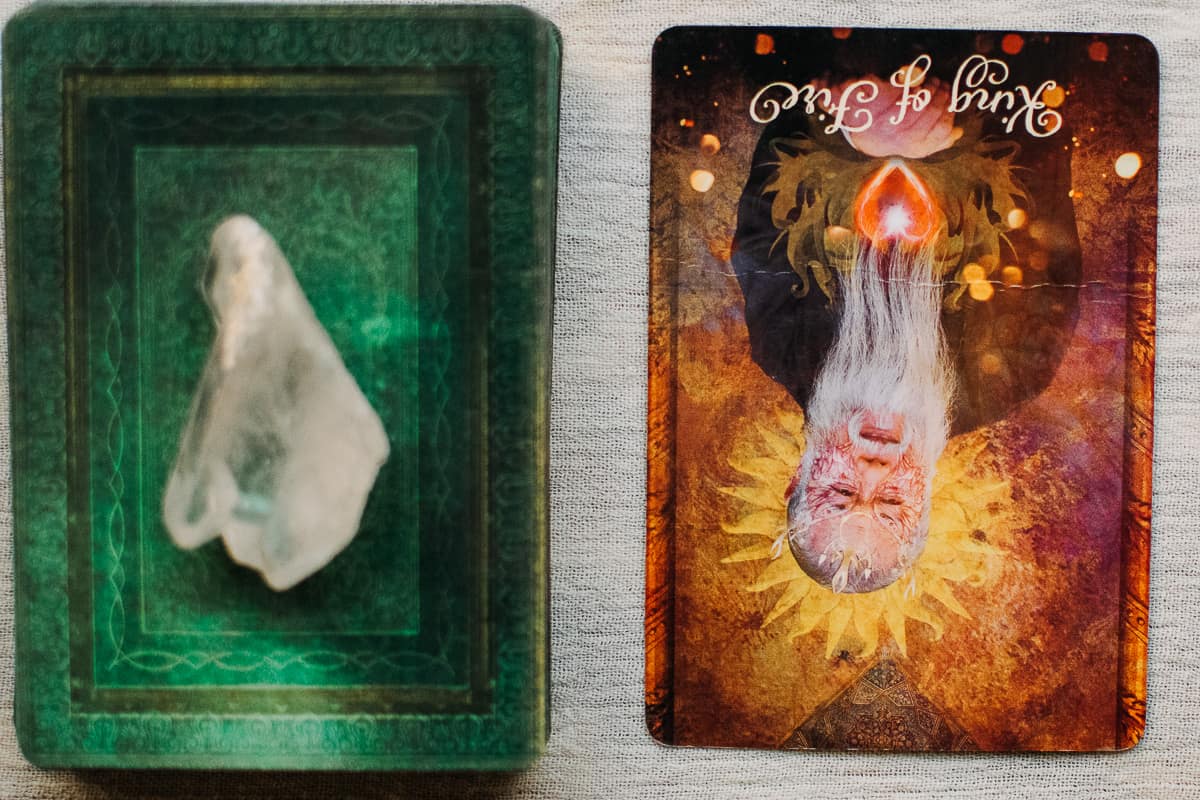 The King of Wands (Fire) card in the reversed position. 