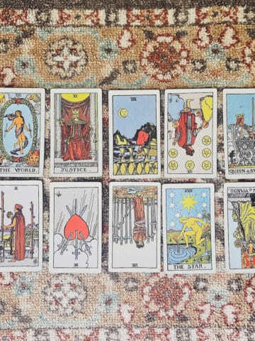 A tarot reading spread with upright and reversed tarot cards.
