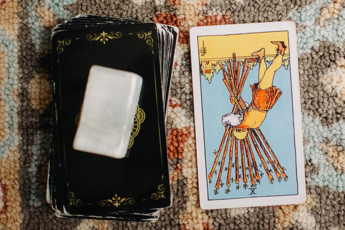 The Ten of Wands tarot card in the reversed position.
