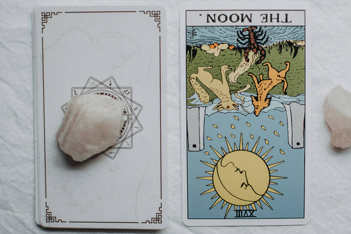 The Moon card in the reversed position (upside down). 