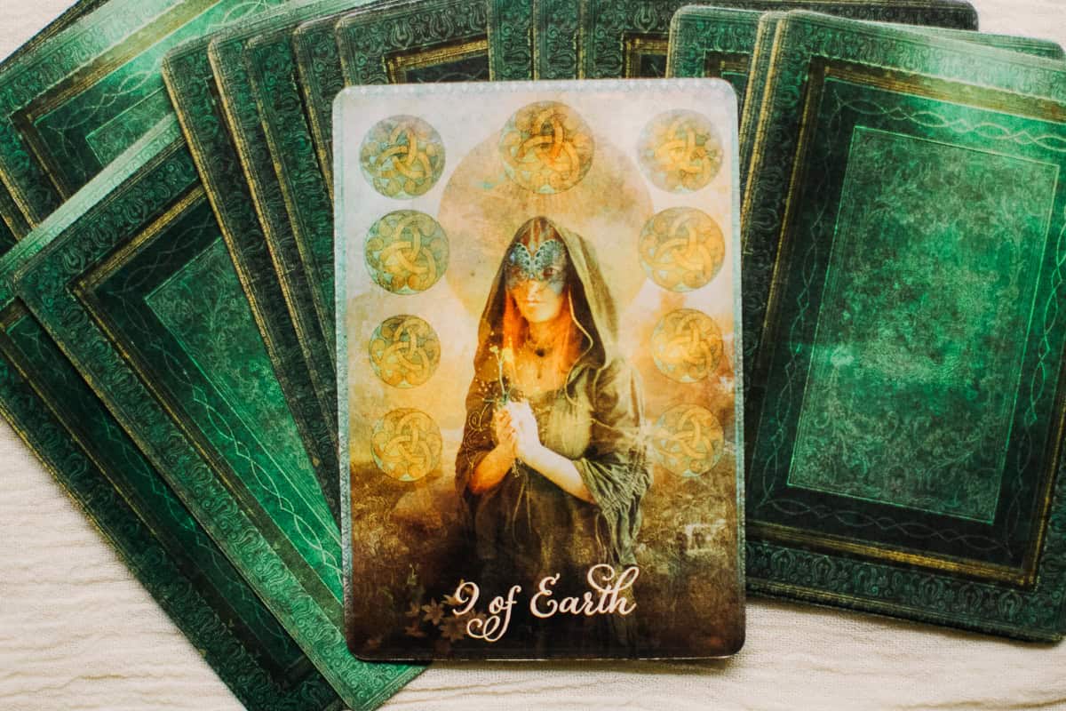 The Nine of Earth tarot card depicted as a person.