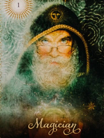 Elderly man with a hooded cloak and a beard and glasses.